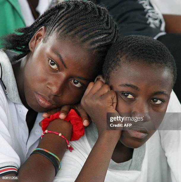 Two Colombian youths watch a dance show celebrating a donation made by an NGO to people displaced by violence at Pedro Grau school in Quibdo,...