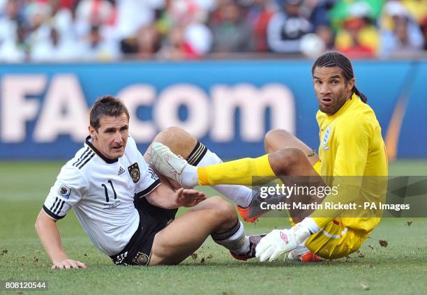 Germany's Miroslav Klose and England goalkeeper David James watch the German's shot on goal go into the back of the net to put Germany 1-0 up.