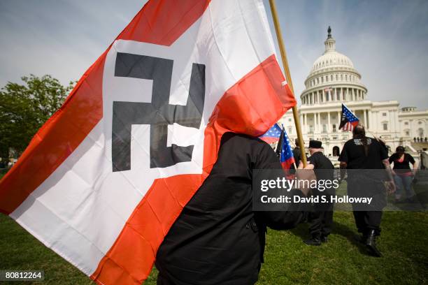 Members of the National Socialist Movement wave American Flags and NSM flags as they march from the Washington Monument to the grounds of the United...