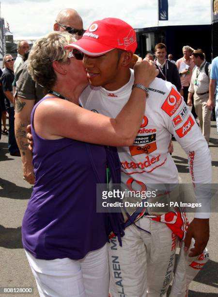 Vodafone McLaren Mercedes' Lewis Hamilton receives a kiss from his mother Carmen Lockhart after he qualified in fourth on Qualifying day ahead of the...