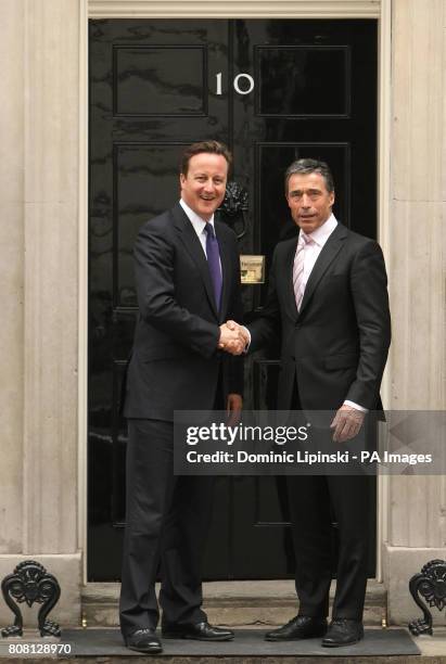 Prime Minster David Cameron greets NATO Secretary General Anders Fogh Rasmussen outside 10 Downing Street, Westminster, London.