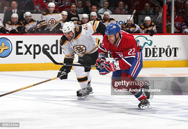 Steve Begin of the Montreal Canadiens races against Mark Stuart of the Boston Bruins for a loose puck during game seven of the 2008 NHL conference...