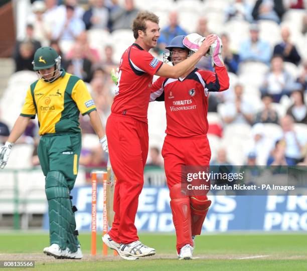 Lancashire Lightning's Tom Smith celebrates taking the wicket of Nottinghamshire Outlaws' Matt Wood with Gareth Cross during the Friends Provident...