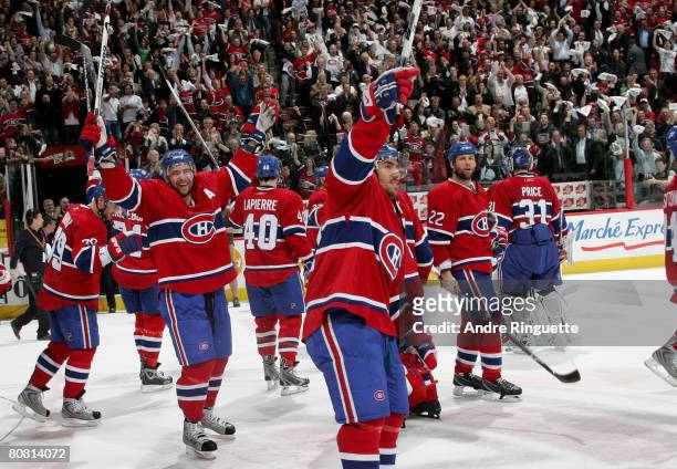 Christopher Higgins and Francis Bouillon of the Montreal Canadiens salute the crowd after their series win against the Boston Bruins during game...