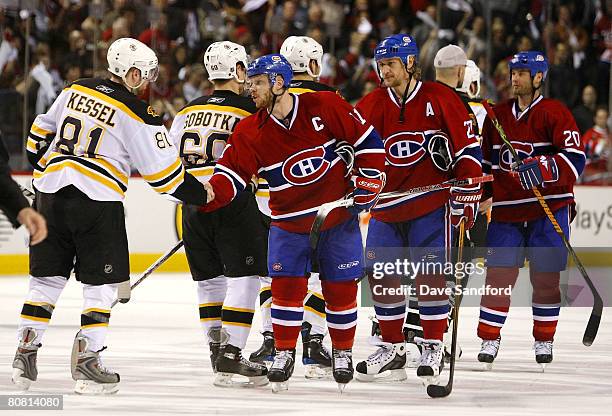 Saku Koivu of the Montreal Canadiens and Phil Kessel of the Boston Bruins shake hands during the post-series tradition during Game Seven of the 2008...