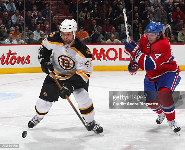 Sergei Kostitsyn of the Montreal Canadiens pressures as Mark Stuart of the Boston Bruins controls the puck during game seven of the 2008 NHL...