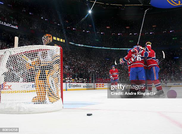 Tim Thomas of the Boston Bruins reacts as members of the Montreal Canadiens celebrate a goal during game seven of the 2008 NHL conference...