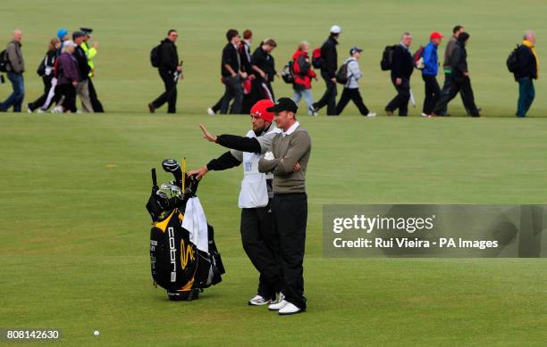 England's Steven Tiley discusses tactics with his caddie Mark Crane as they finish off round two on day three of The Open Championship 2010 at St...