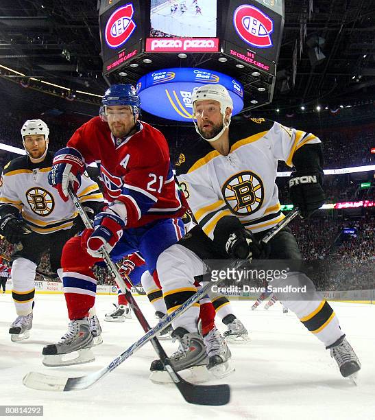 Christopher Higgins of the Montreal Canadiens and Glen Metropolit of the Boston Bruins battle for position during Game Seven of the 2008 NHL Eastern...