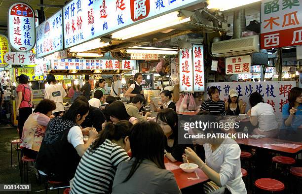 Taiwan-China-politics-economy-tourism by Benjamin Yeh Customers are seen dining at the famous Shihlin night market, a popular tourist spot in Taipei...