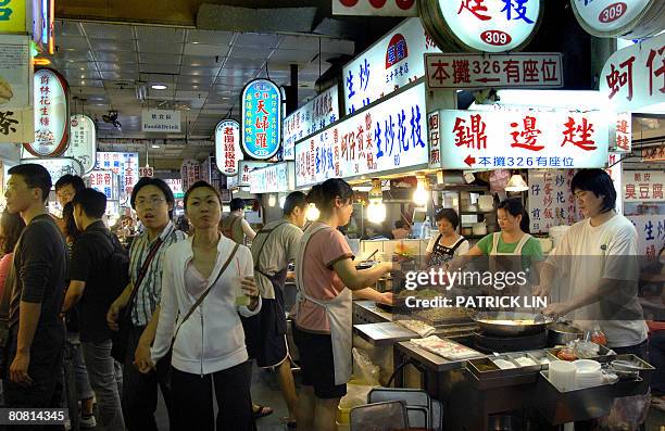 Taiwan-China-politics-economy-tourism by Benjamin Yeh Customers stroll the alleys of the famous Shihlin night market, a popular tourist spot in...