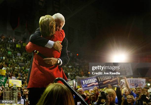 Democratic presidential hopeful Senator Hillary Clinton is hugged by her husband former President Bill Clinton during a campaign rally at University...