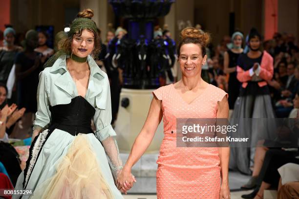Designer Anja Gockel acknowledges the applause of the audience at the Anja Gockel show during the Mercedes-Benz Fashion Week Berlin Spring/Summer...