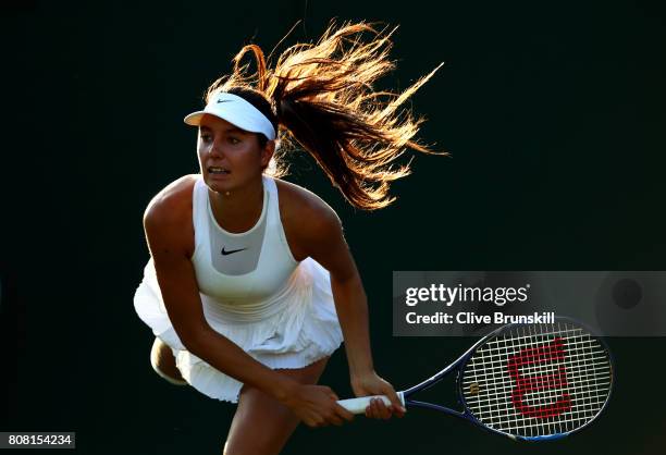 Oceane Dodin of France serves during the Ladies Singles first round match against Lucie Safarova of The Czech Republic on day two of the Wimbledon...