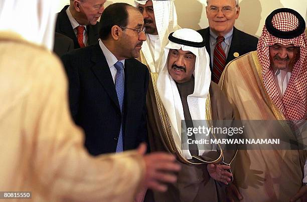 Iraqi Prime Minister Nuri al-Maliki leaves hand in hand with Kuwaiti Prime Minister Sheikh Nasser Mohammed al-Ahmed al-Sabah along with Saudi Foreign...