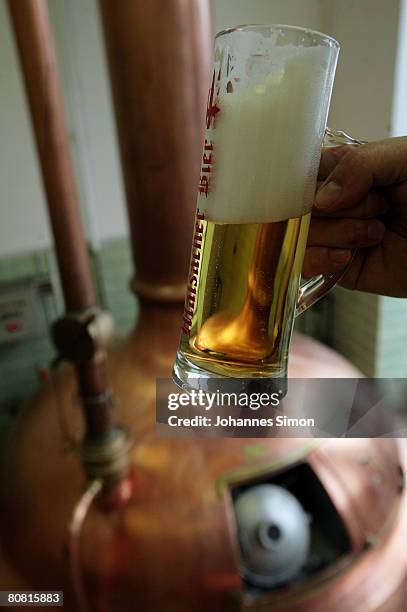 Freshly drawn beer is seen in front of a mash tank at the Maisacher brewery, on April 22, 2008 in Maisach near Munich, Germany. Beer is regarded as...