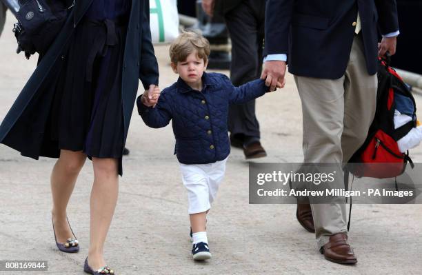 James Wessex holds the hand of his mother the Countess of Wessex and Peter Phillips as they disembark from the Hebridean Princess boat after a family...