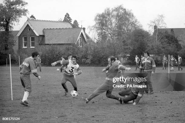 England soccer manager Don Revie in action as he joins his squad in training at Whetstone, north London. No. 3 is David Clement, extreme left is...