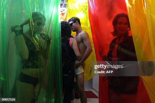 People participate on April 19, 2008 in the 12th Erotika Fair, Latin America's biggest erotica trade show, held at the exhibition hall Mart Centre in...