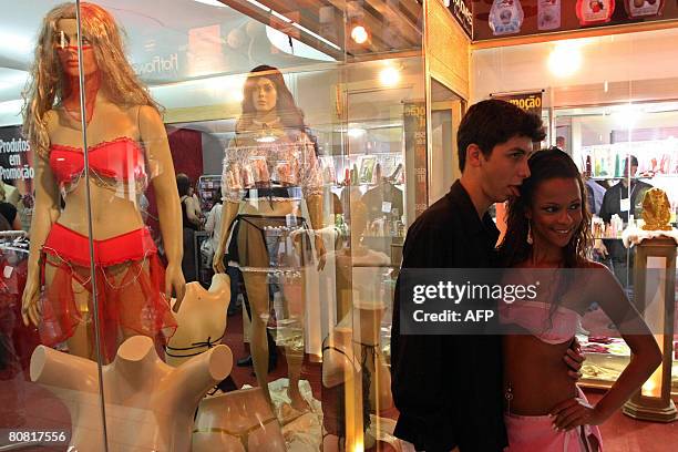 Man and a woman pose on April 19, 2008 during the 12th Erotika Fair, Latin America's biggest erotica trade show, held at the exhibition hall Mart...