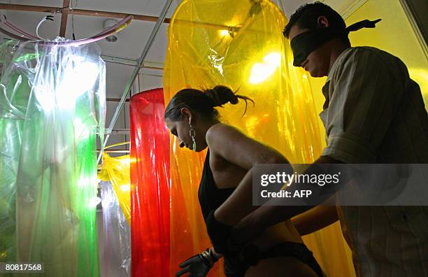 Visitor participates on April 19, 2008 in the 12th Erotika Fair, Latin America's biggest erotica trade show, held at the exhibition hall Mart Centre...