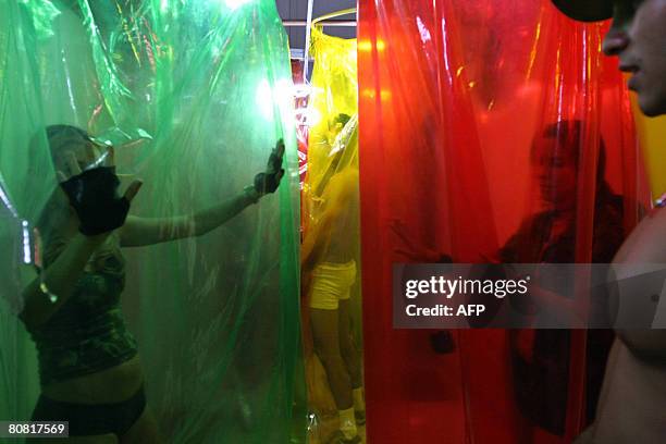 People participate on April 19, 2008 in the 12th Erotika Fair, Latin America's biggest erotica trade show, held at the exhibition hall Mart Centre in...