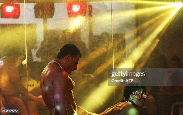 Man and a woman perform a show on April 19, 2008 during the 12th Erotika Fair, Latin America's biggest erotica trade show, held at the exhibition...