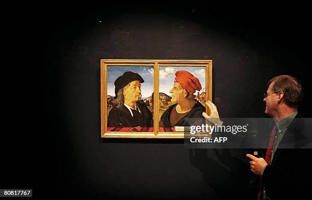 Amsterdam Rijksmuseum's curator Duncan Bull curator gestures on April 22, 2008 as he comments the restoration of two paintings, part of the important...
