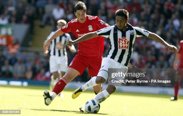 Liverpool's Fernando Torres and West Brom's Jonas Olsson battle for the ball during the Barclays Premier League match at Anfield, Liverpool.