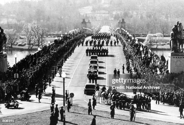 The funeral procession of President John F. Kennedy goes into Arlington Cemetary in Washington. On November 22 Kennedy was killed by an assassin's...