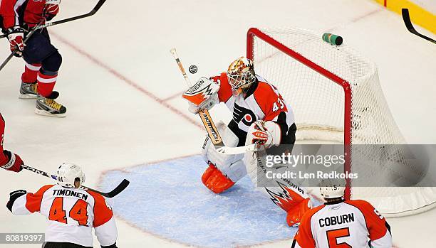 Martin Biron of the Philadelphia Flyers stops a shot on goal against the Washington Capitals during game five of the Eastern Conference Quarterfinals...