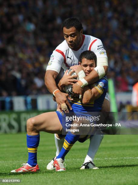 Leeds Rhinos' Brent webb is tackled by St Helens' Tony Puletua during the Carnegie Challenge Cup Semi Final match at the Galpharm Stadium,...