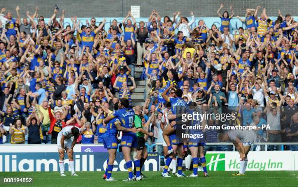 Leeds Rhinos players and fans celebrate their victory during the Carnegie Challenge Cup Semi Final match at the Galpharm Stadium, Huddersfield.
