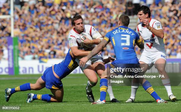 St Helens' Bryn Hargreaves is is tackled by Leeds Rhinos' Chris Clarkson and Brett Delaney during the Carnegie Challenge Cup Semi Final match at the...