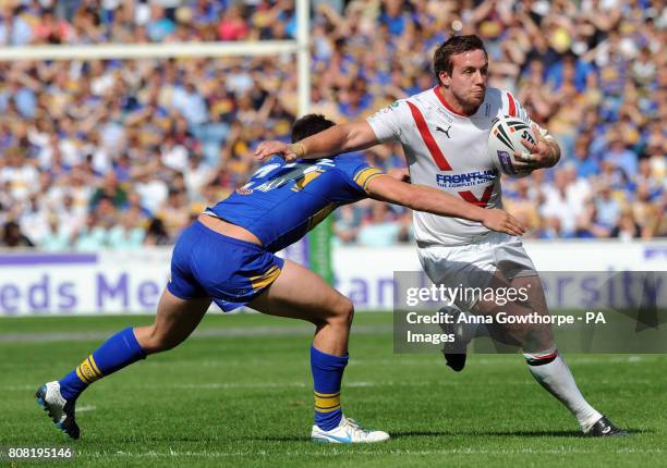 St Helens' Bryn Hargreaves is is tackled by Leeds Rhinos' Chris Clarkson during the Carnegie Challenge Cup Semi Final match at the Galpharm Stadium,...