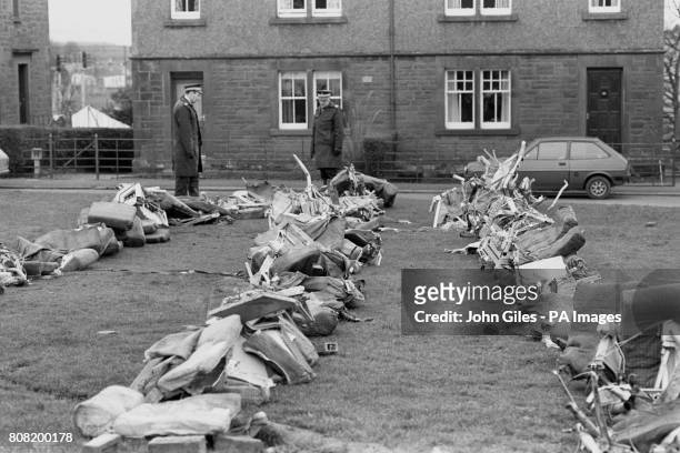 Police officers view a row of aircraft seats from the crashed Pan Am Boeing 103. The plane was bombed and came down on the town of Lockerbie, killing...