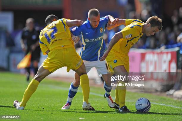 Wycombe Wanderers' Lewis Montrose and Danny Foster tackle Stockport County's Danny Rowe during the npower League Two match at Edgeley Park, Stockport.
