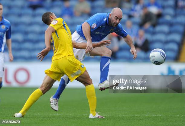 Stockport County's Barry Conlon and Wycombe Wanderers' Lewis Montrose battle for the ball during the npower League Two match at Edgeley Park,...