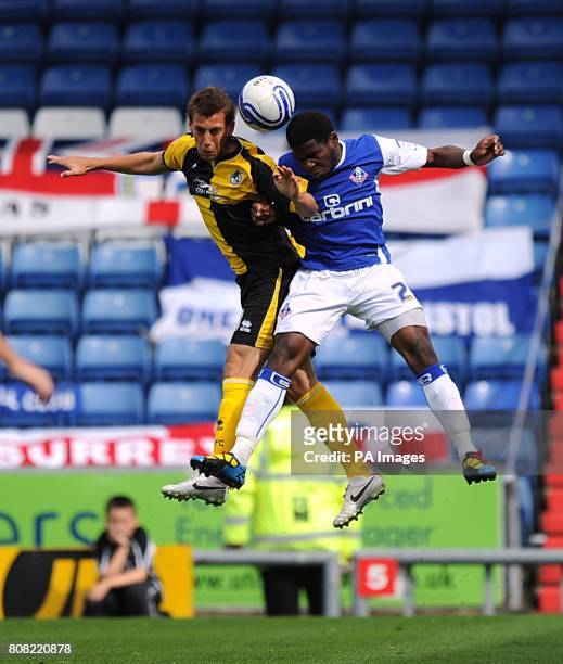 Bristol Rovers' Gary Sawyer and Oldham Athletic's Rodrigue Dikaba battle for the ball
