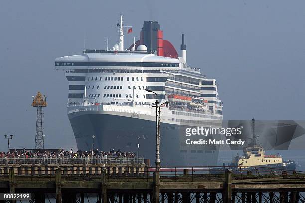 People watch from the quay side as the cruise liner Queen Mary 2 begins to moves on April 22 2008 in Southampton, England. The Queen Mary was one of...