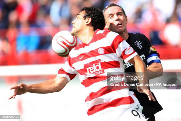 Hamilton's Damian Casalinuovo and Rangers' David Weir battle for the ball during the Clydesdale Bank Scottish Premier League match at New Douglas...