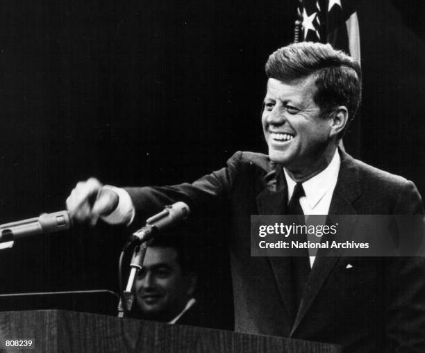 President John F. Kennedy laughs during a press conference August 9, 1963.