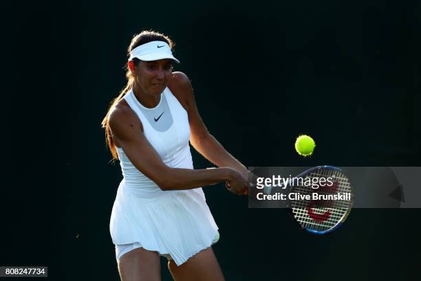 Oceane Dodin of France plays a backhand during the Ladies Singles first round match against Lucie Safarova of The Czech Republic on day two of the...