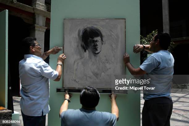 Workers install a painting of Jose Luis Cuevas before an homage to Mexican artist at Jose Luis Cuevas Museum on July 04, 2017 in Mexico City, Mexico....