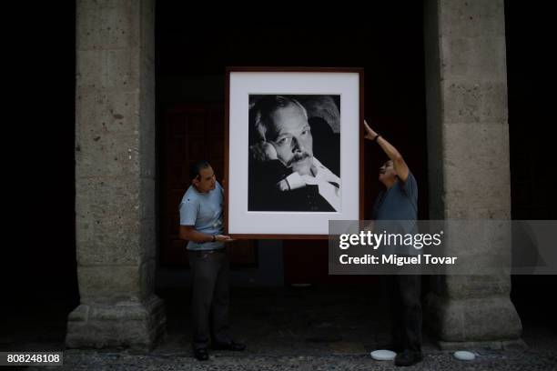 Workers install a portrait of Jose Luis Cuevas before an homage to Mexican artist at Jose Luis Cuevas Museum on July 04, 2017 in Mexico City, Mexico....