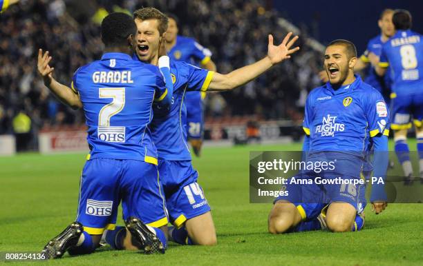 Leeds United's Jonathan Howson celebrates his goal with Max Gradel and Bradley Johnson during the npower Championship match at Oakwell, Barnsley.