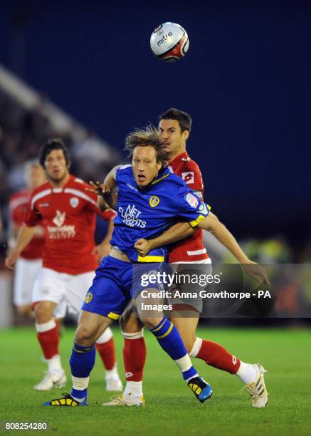 Leeds United's Luciano Becchio and Barnsley's Jason Shackell battle for the ball during the npower Championship match at Oakwell, Barnsley.