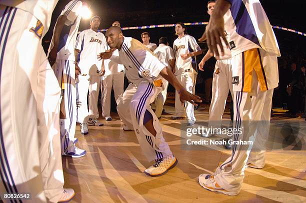 Kobe Bryant of the Los Angeles Lakers celebreates with his teammates as he enters the court in Game One of the Western Conference Quarterfinals...