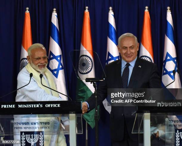 Indian Prime Minister Narendra Modi and Israeli Prime Minister Benjamin Netanyahu shake hands following a statement on July 4 at the Netanyahu's...