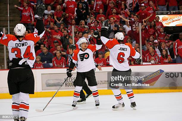 Sami Kapanen celebrates his 2nd period goal with teammates Randy Jones and Jim Dowd of the Philadelphia Flyers against the Washington Capitals during...